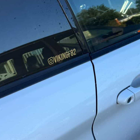 Sticker doré personnalisé @VIKINGF82 sur vitre arrière BMW Série 1 blanche